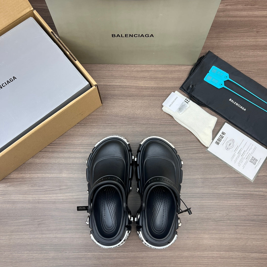Pair of black Balenciaga sandals with thick sole, toe-covered upper, and side straps