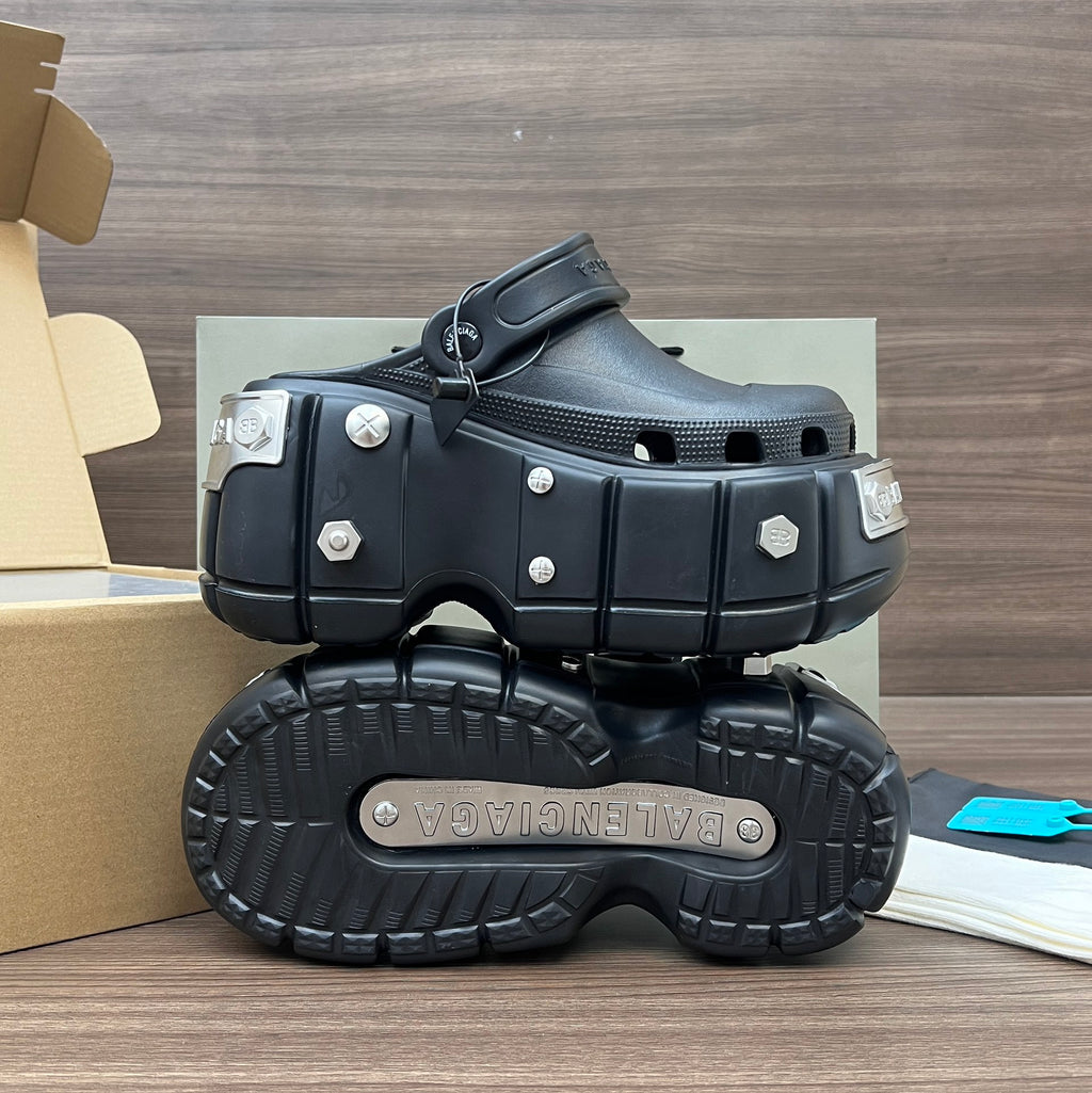 Black Balenciaga sandals showing treaded outsole and studded platform with side straps