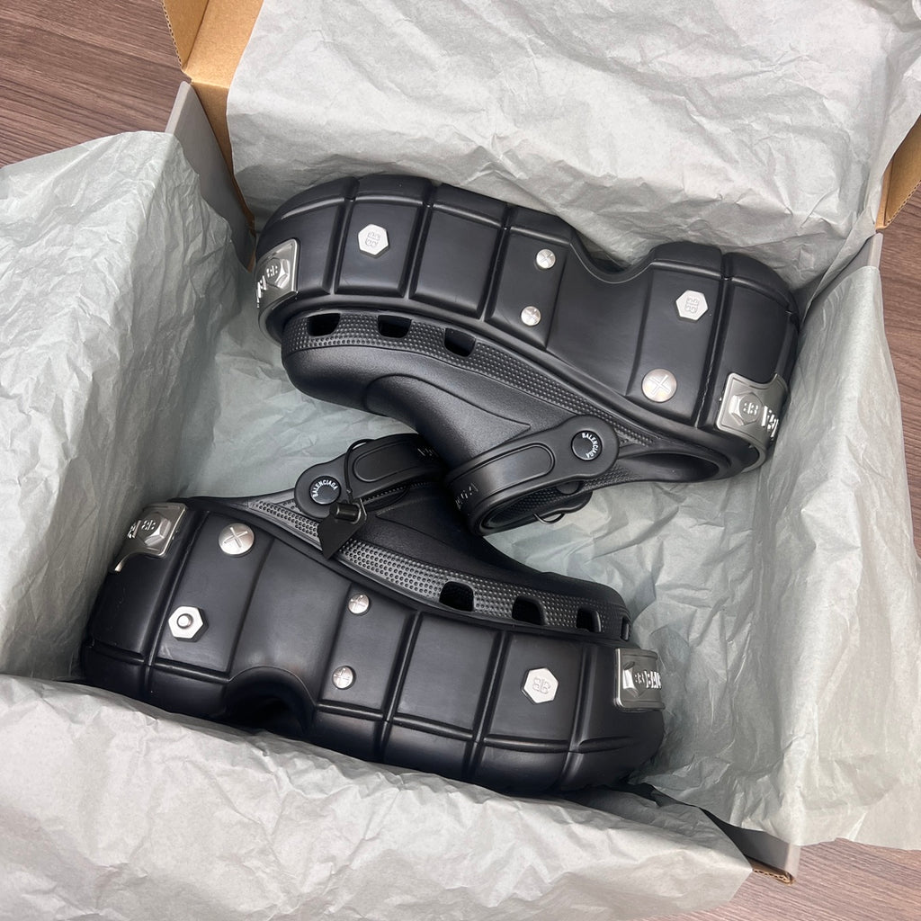 Black Balenciaga sandals with stud accents and thick tread platform sole in box wrapping