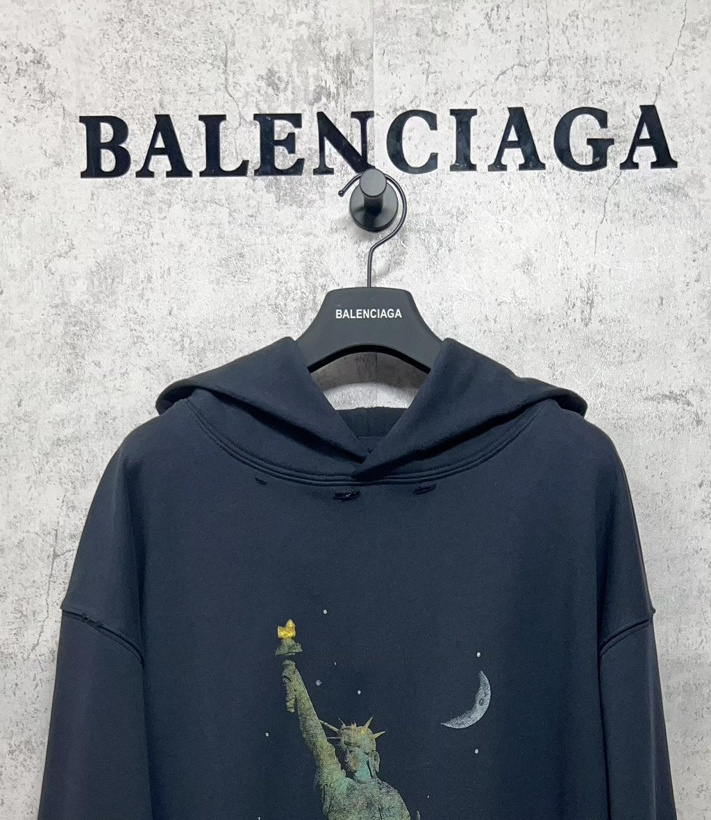 Balenciaga hooded sweatshirt, dark navy, front view with hood and liberty-themed graphic