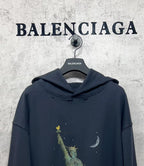 Balenciaga hooded sweatshirt, dark navy, front view with hood and liberty-themed graphic