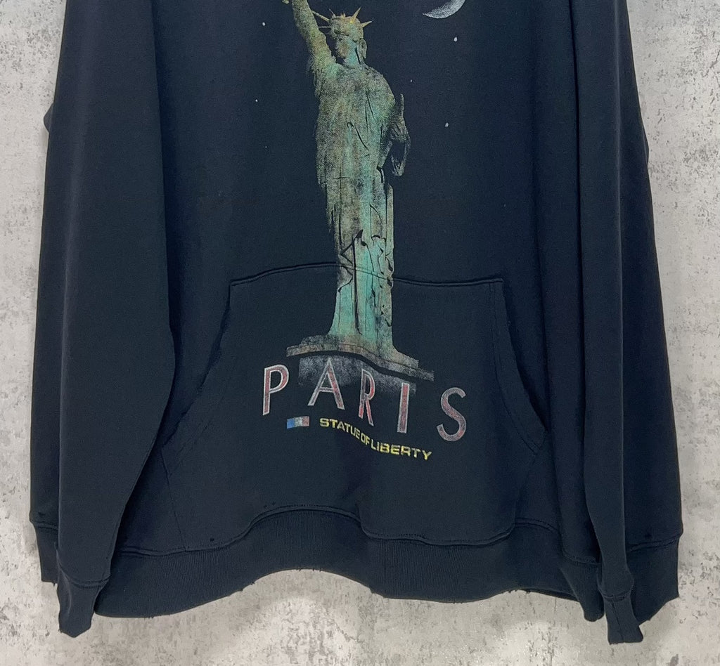 Balenciaga hooded sweatshirt detail: "PARIS" text and Statue of Liberty graphic