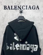 Black hoodie with hood and white Balenciaga logo print on the back