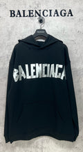 Black long-sleeve hoodie with white Balenciaga logo print and front kangaroo pocket