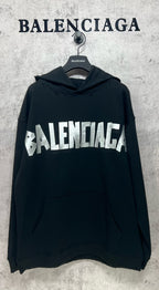 Black long-sleeve hoodie with white Balenciaga logo print and front kangaroo pocket
