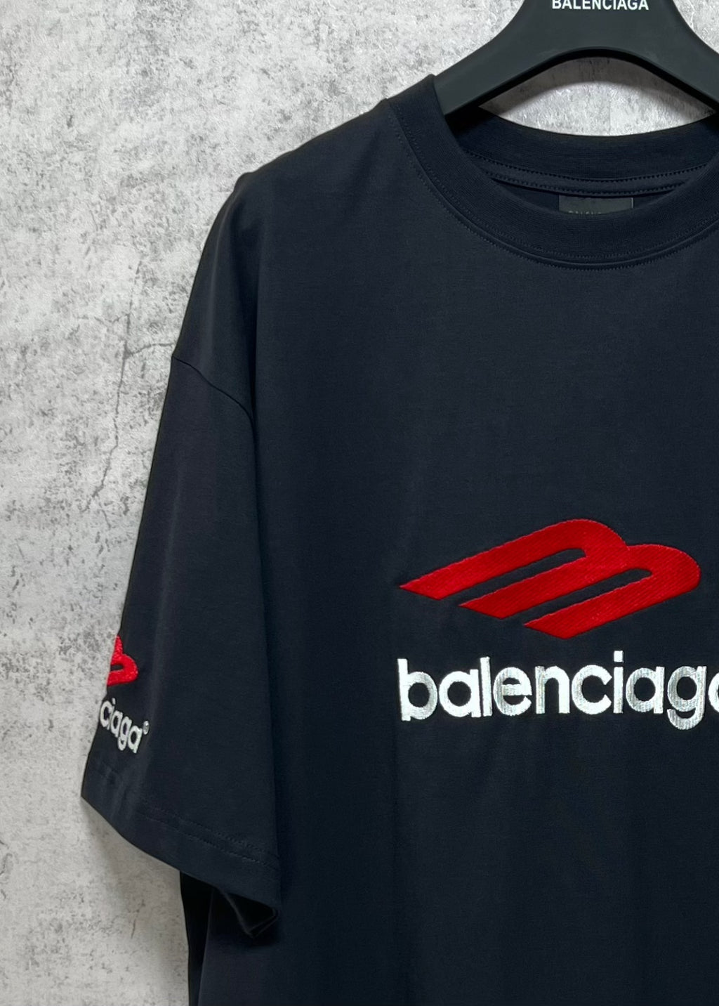 Balenciaga logo T-shirt, dark fabric with red logo patch on front sleeve area