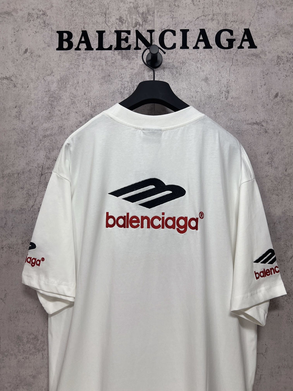 White short-sleeve T-shirt back view with Balenciaga logo print and logo on sleeve.