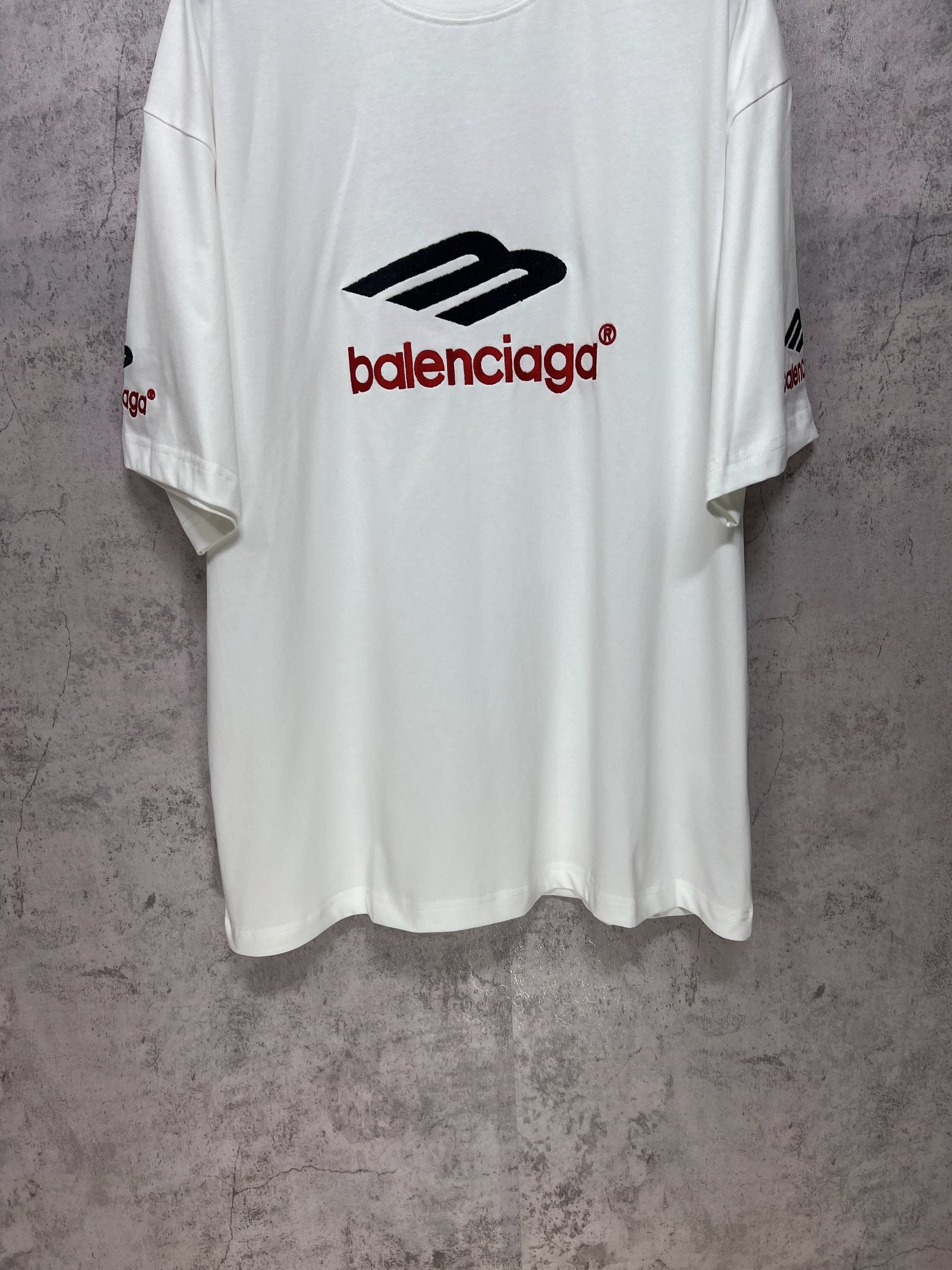 White short-sleeve T-shirt front view with Balenciaga logo on chest.