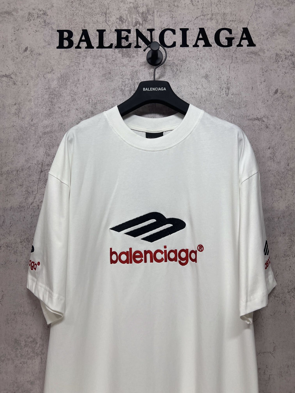 White short-sleeve T-shirt with large Balenciaga logo on chest, crew neck.