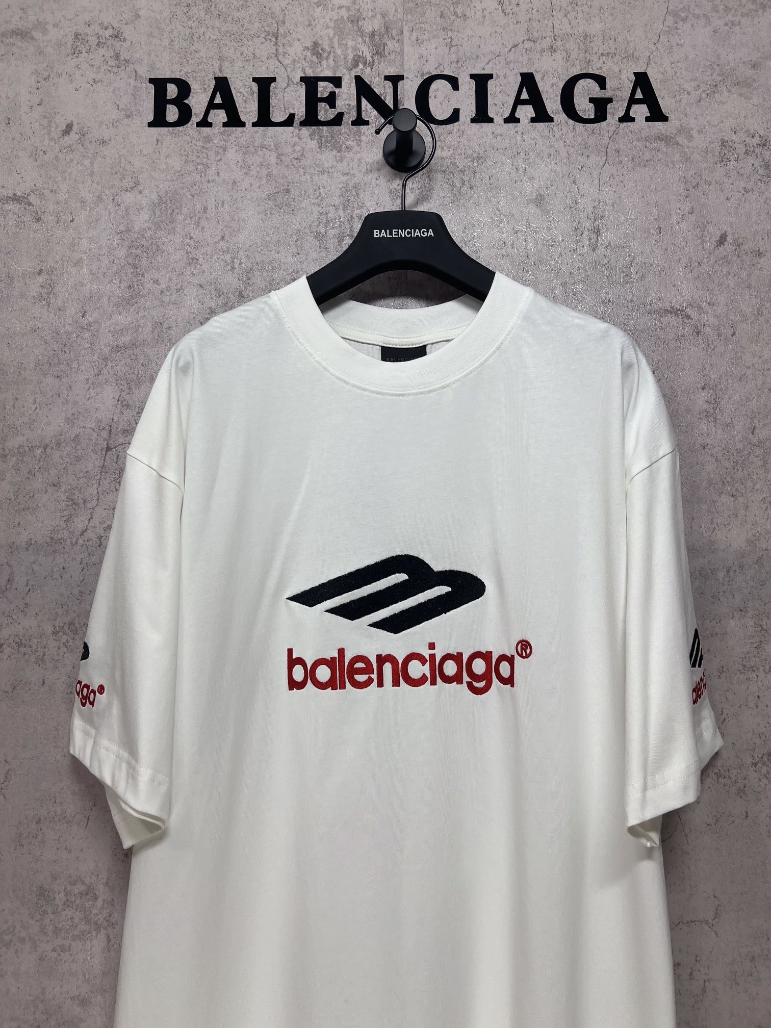 White short-sleeve T-shirt with large Balenciaga logo on chest, crew neck.