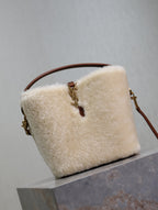 Cream shearling-look YSL bag with brown strap and gold hardware, front flap
