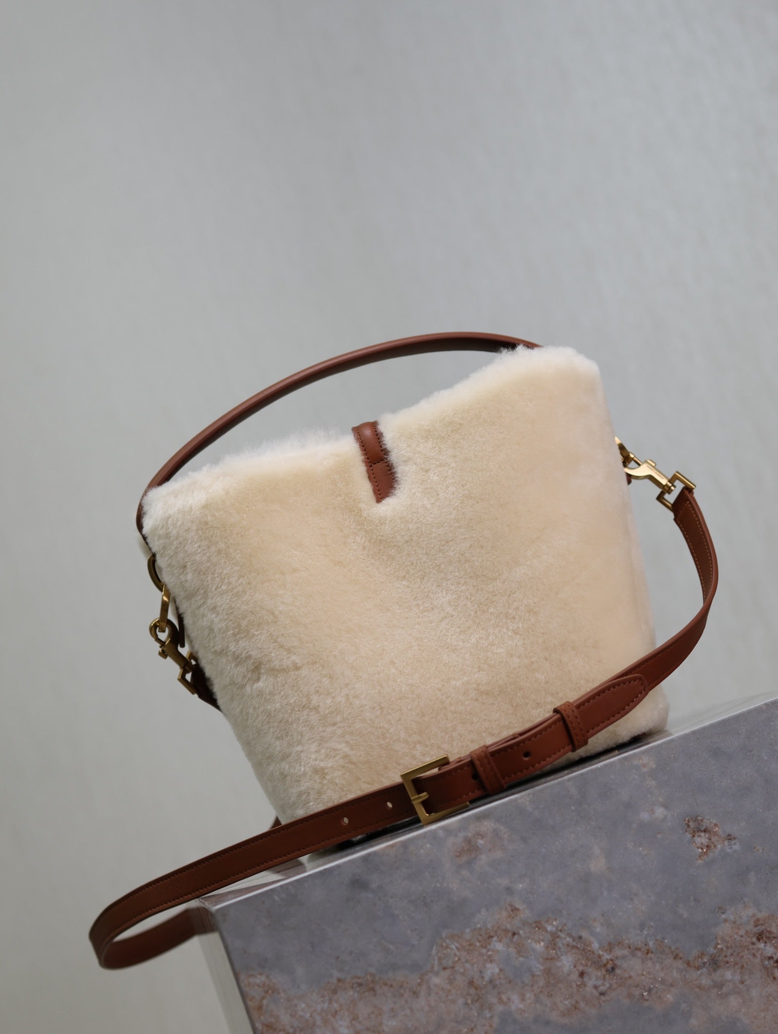 Cream shearling-look YSL bag with brown crossbody strap and gold chain hardware