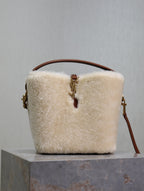 Cream shearling-look YSL bag with brown top handle and gold zipper pull
