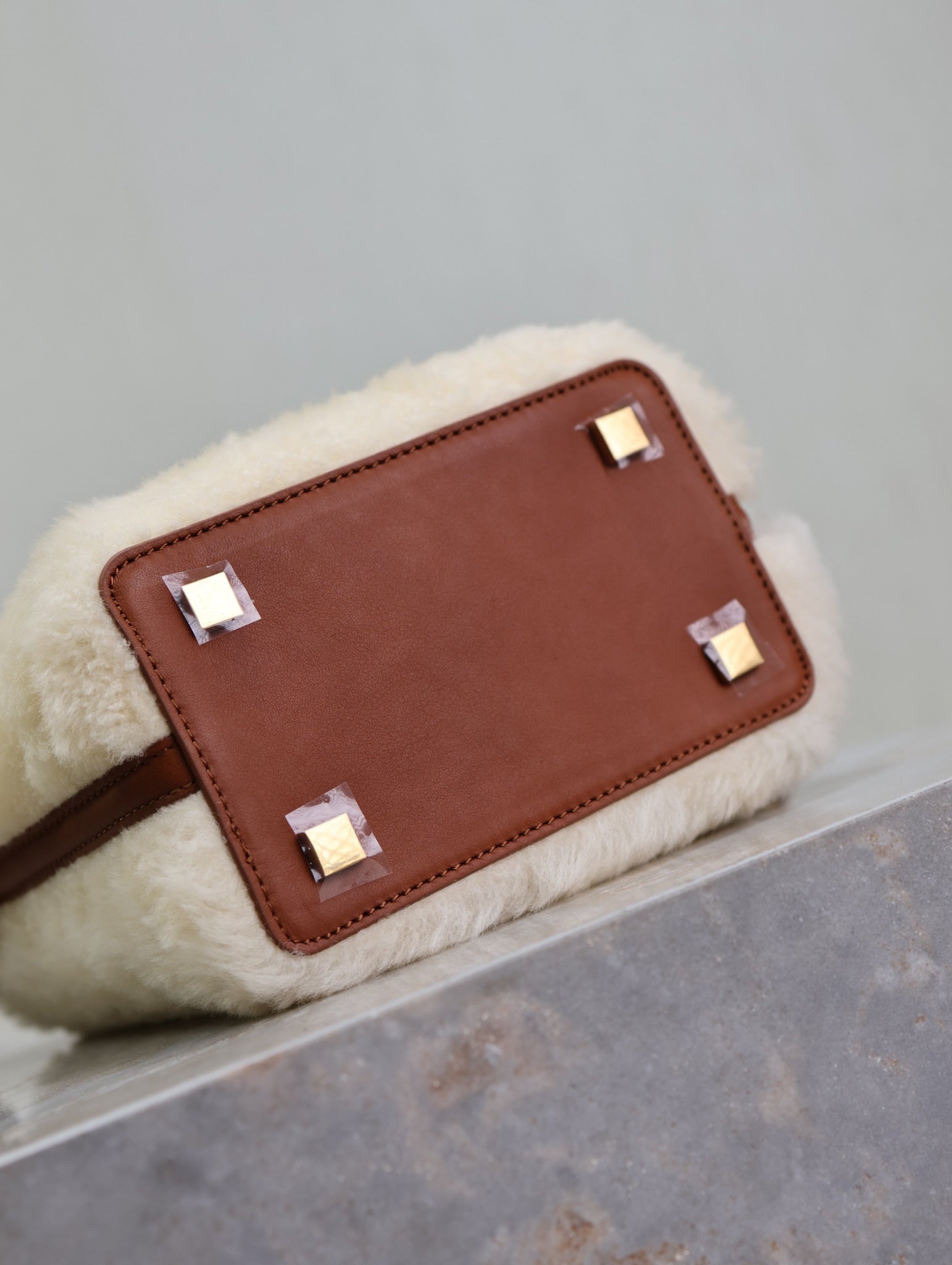 YSL faux fur bag with brown leather front panel and gold-tone square studs