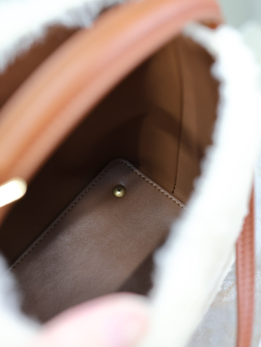 YSL faux fur bag interior with brown lining and metal snap-button pocket