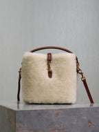 YSL faux fur bucket bag with brown leather top handle and front tab closure