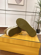 Fendi low-top sneakers outsole view on the box; tan tread with Fendi logo