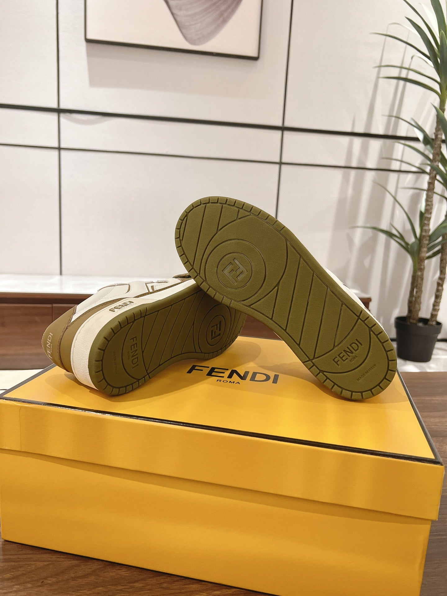 Fendi low-top sneakers outsole view on the box; tan tread with Fendi logo