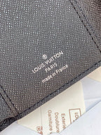 Small bag wallet close-up with “Louis Vuitton Paris” stamped on leather