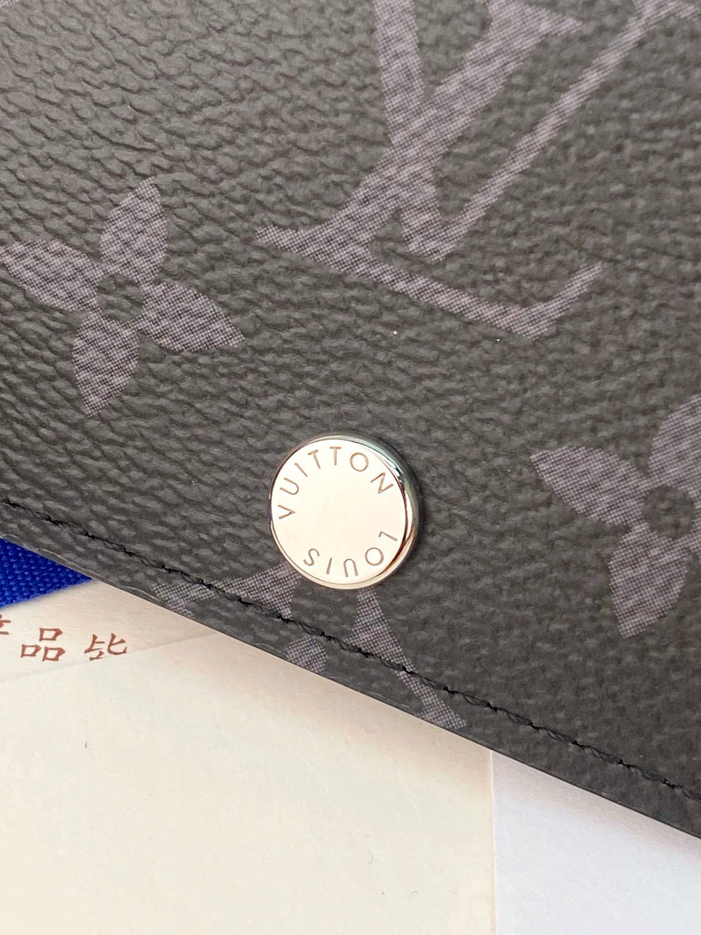Small bag wallet close-up of round snap button on textured leather