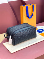 Louis Vuitton embossed monogram toiletry bag with top zip and carry handle, dark