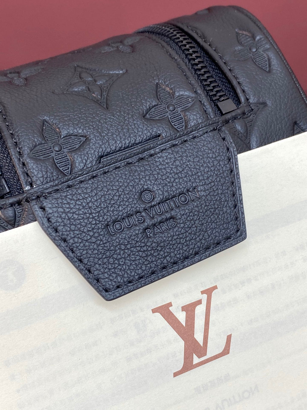 Monogram toiletry bag front pocket with zipper and embossed Louis Vuitton stamp