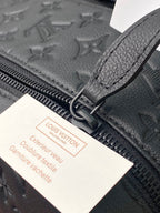 Close-up of zip track and leather pull tab with warranty tag on toiletry bag