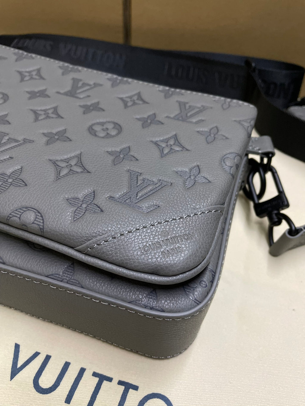 Men's Louis Vuitton gray monogram crossbody flap close-up with contrast trim