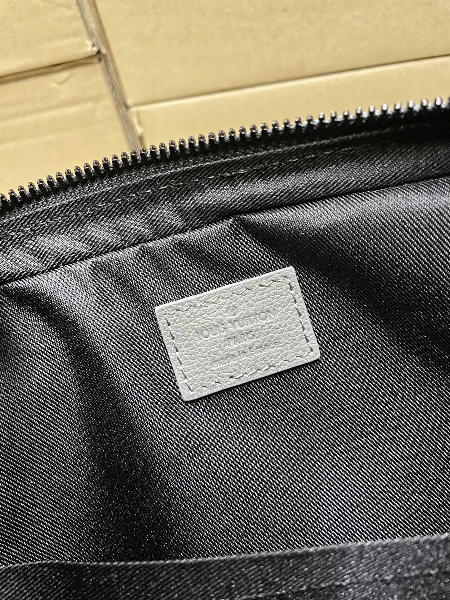 Men's Louis Vuitton bag interior pocket lining with brand patch
