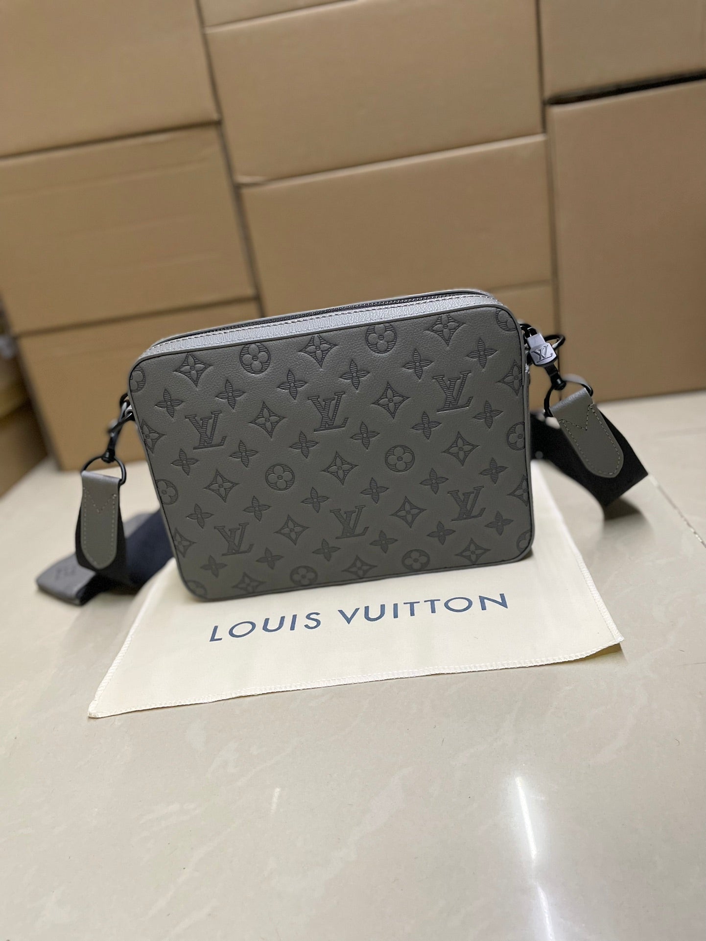 Men's Louis Vuitton crossbody bag, gray monogram, rear view with shoulder strap