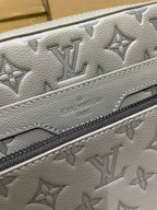Men's Louis Vuitton gray monogram leather panel close-up with zipper edge