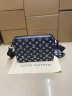 Louis Vuitton crossbody bag, navy monogram print with crossbody strap and small charm