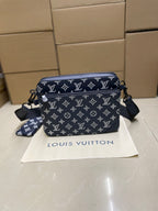 Men's Louis Vuitton crossbody bag, navy monogram with zip top and shoulder strap.