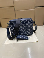 Men's Louis Vuitton crossbody bag, navy monogram with adjustable strap and zip top.