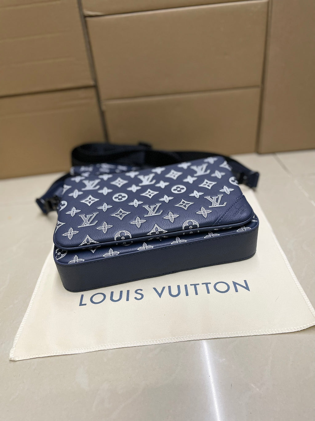 Men's Louis Vuitton crossbody bag, navy monogram with zip closure and base profile.