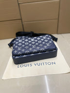 Louis Vuitton crossbody bag, navy monogram print on front with zipper closure