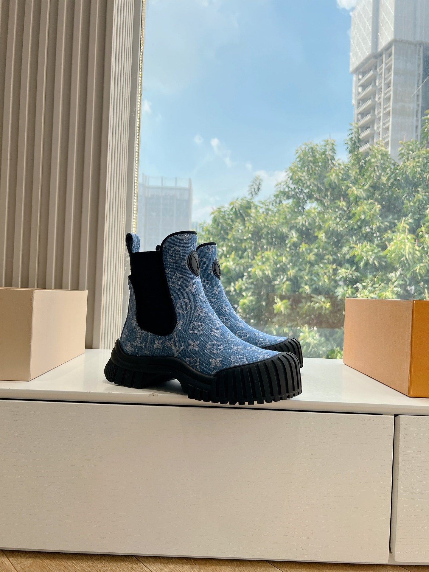 Blue patterned ankle Chelsea boots with black elastic panels and thick ribbed rubber soles
