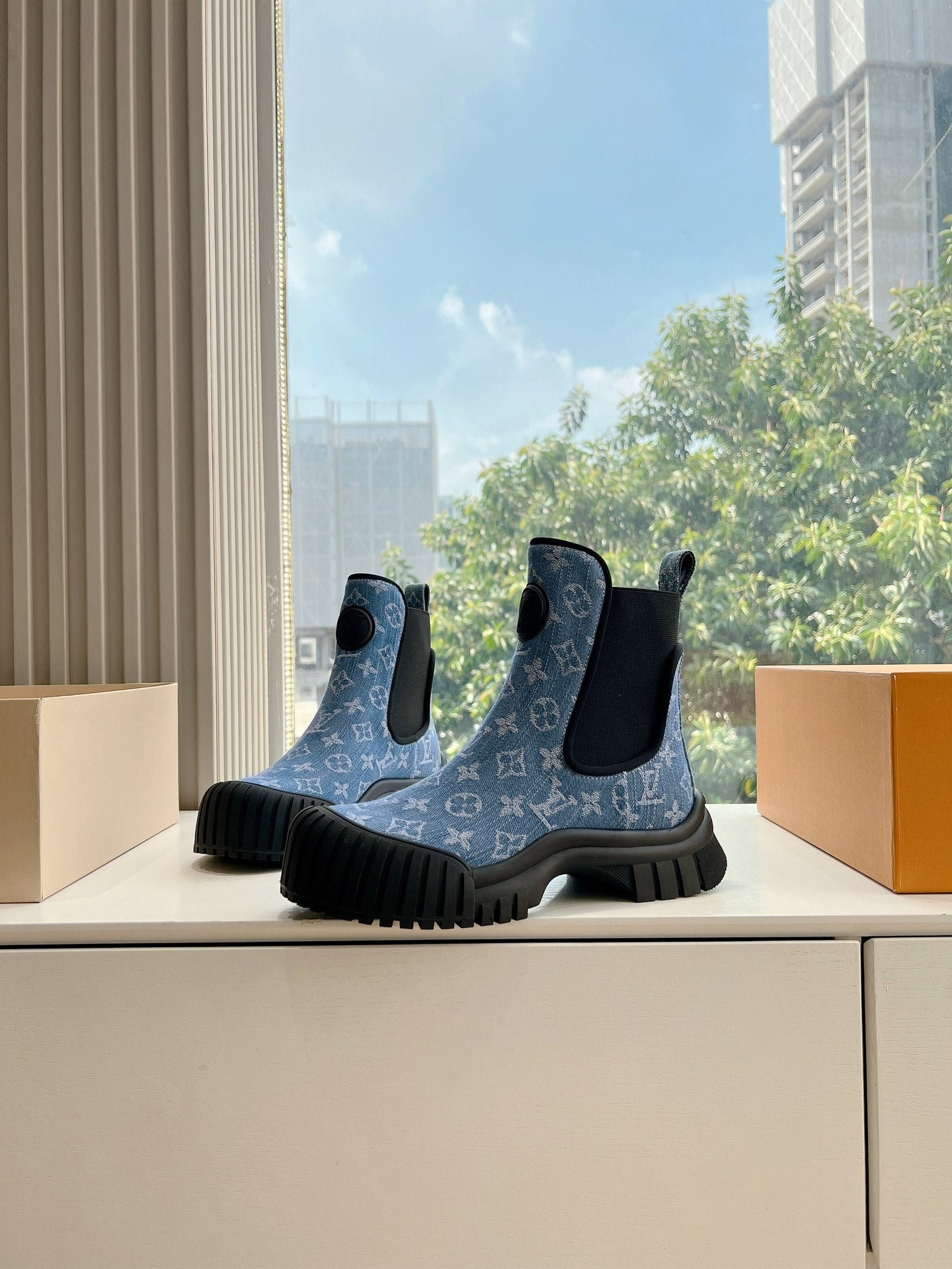 Pair of blue monogram Chelsea boots with black side elastic and chunky tread rubber soles