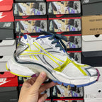 Balenciaga unisex sneakers side profile, white upper with neon yellow stripe and blue laces