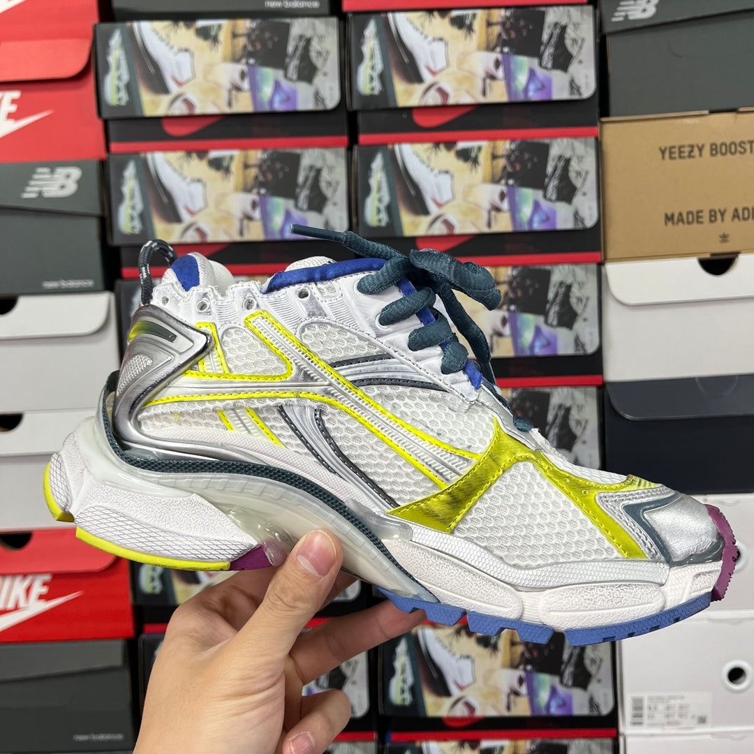 Balenciaga unisex sneakers side profile, white upper with neon yellow stripe and blue laces