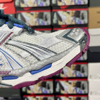 Balenciaga unisex sneaker side view, white and silver with blue laces and purple outsole