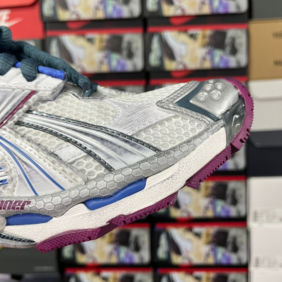 Balenciaga unisex sneaker side view, white and silver with blue laces and purple outsole