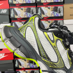 Balenciaga unisex sneakers angled view: white mesh, neon green trim, black lace-up