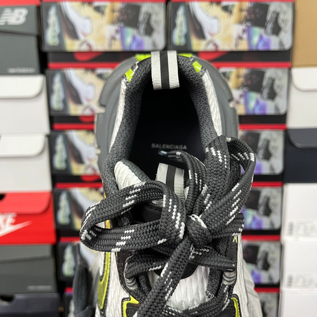 Balenciaga unisex sneaker rear view: black upper with white accents and neon green piping