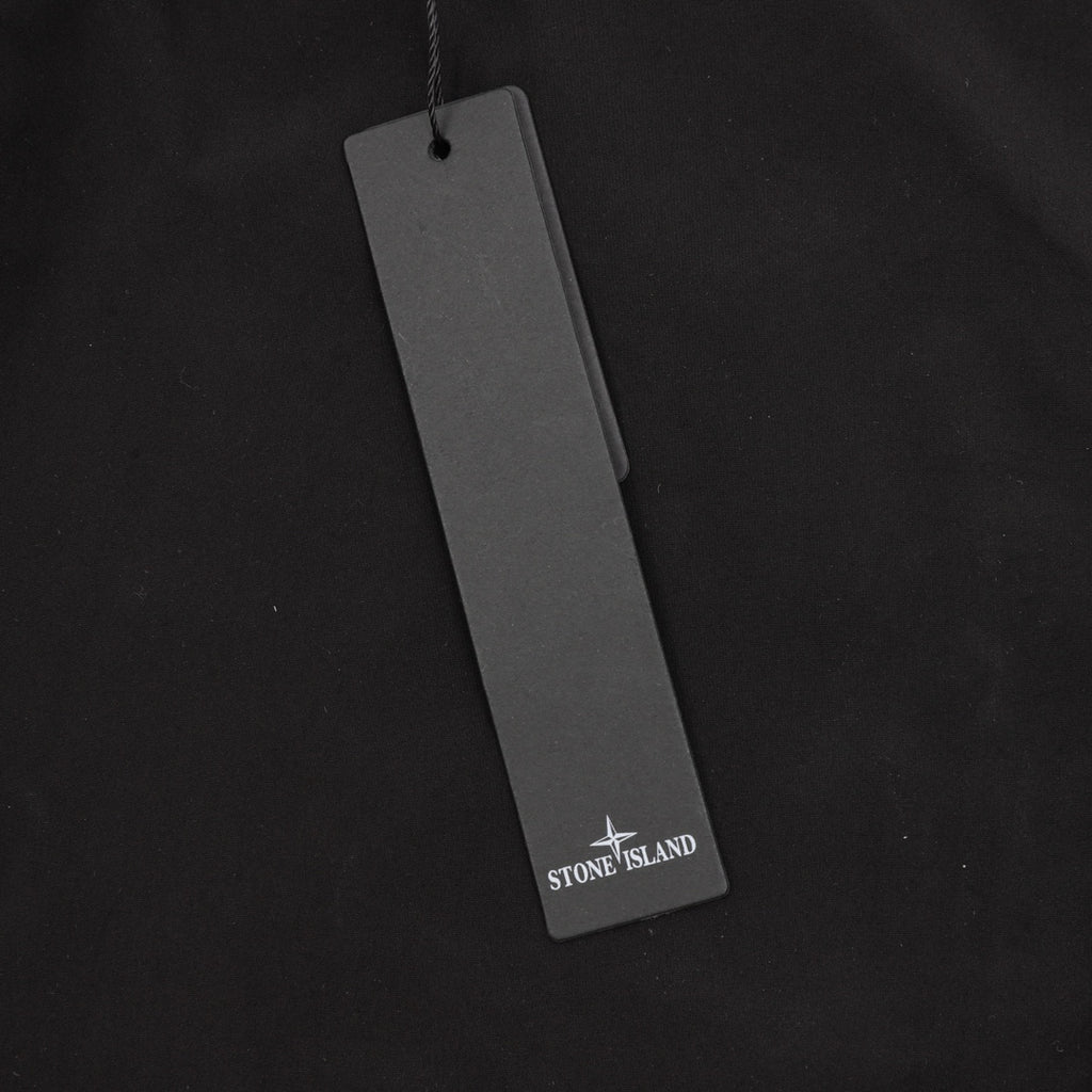 Black cargo shorts with hanging Stone Island tag