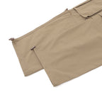 Beige shorts hem close-up with side button tabs and drawstring ends