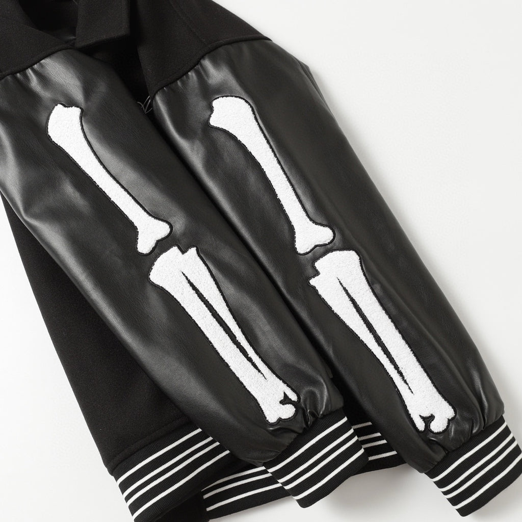 Black jacket sleeves with white bone graphic and striped ribbed cuffs