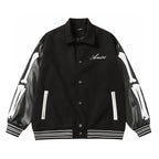 Black varsity jacket with collar, snap buttons, Amiri script logo, ribbed hem and cuffs