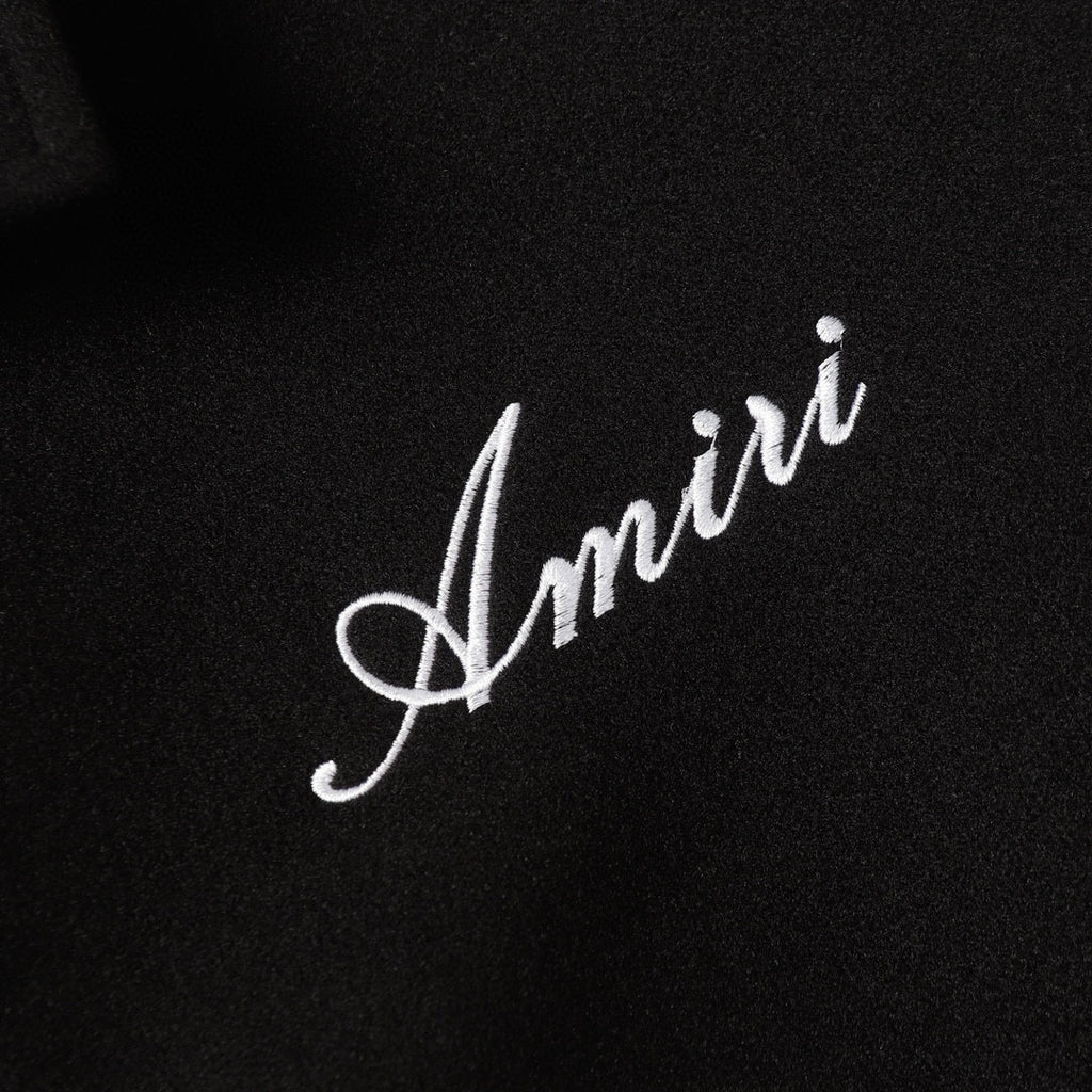 Amiri script embroidery on black fabric