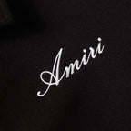 Amiri script embroidery on black fabric